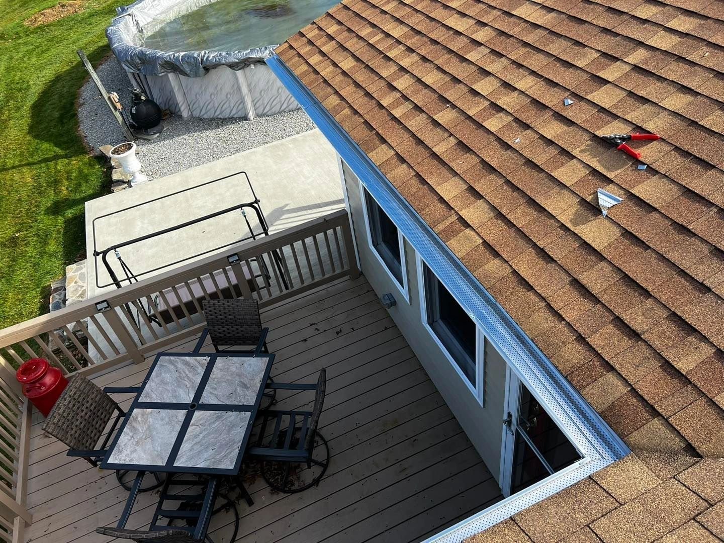 Close view of a gutter beside a shingled roof
